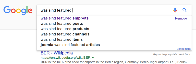 Googlesuche "was sind featured" mit Suggest-Funktion